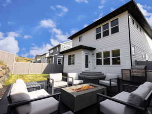 View of patio with an outdoor living space with a fire pit and exterior kitchen