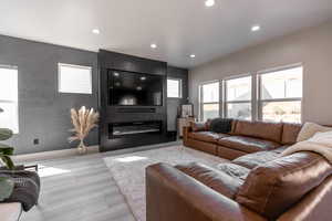 Living room with recessed lighting and a fireplace