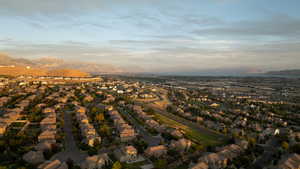 Aerial view of property and surrounding area with a mountain backdrop and nearby suburban area
