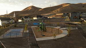 View of mountain backdrop featuring pickleball court, playground and community area.