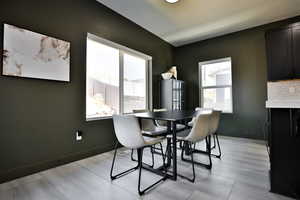 Dining space with baseboards and light tile patterned flooring