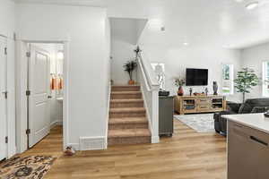 Kitchen featuring light wood finished floors, a textured ceiling, and recessed lighting