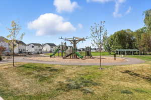 Community jungle gym with a yard and a residential view