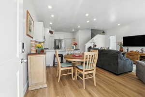 Dining space featuring light wood-style flooring and recessed lighting