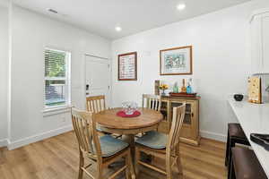 Dining space featuring light wood-style floors and recessed lighting