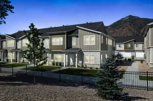 View of front of home featuring board and batten siding, stone siding, and a residential view