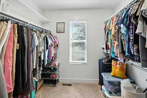 Walk in closet featuring carpet