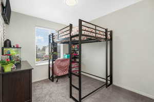 Carpeted bedroom featuring baseboards