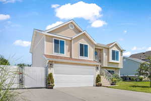 View of front of home featuring stucco siding, an attached garage, brick siding, and concrete driveway
