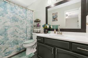 Full bathroom featuring tile patterned flooring, vanity, a shower with shower curtain, and ceiling fan