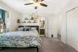 Carpeted bedroom with baseboards and a ceiling fan
