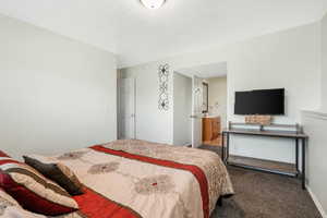 Bedroom with carpet flooring and baseboards