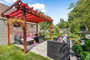 Fenced backyard with an outdoor living space, a pergola, and a patio
