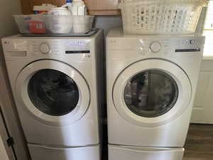 Washroom featuring washer and clothes dryer and wood finished floors