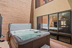 View of patio / terrace featuring a hot tub