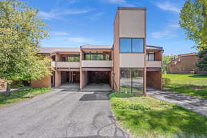 Contemporary house featuring brick siding and stucco siding
