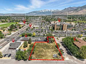 Aerial overview of property's location with a mountain backdrop and property boundaries highlighted