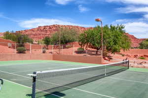 View of tennis court with a mountain view