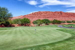 View of property's community with a putting green, a mountain view, and golf course view