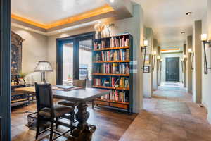 Office space featuring wood-type flooring, recessed lighting, and a raised ceiling