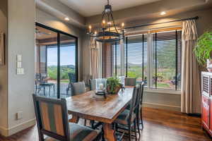 Dining area with a chandelier, wood-type flooring, recessed lighting, and ceiling fan