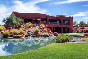 Back of property with a yard