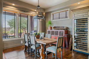 Dining room with wine cooler, recessed lighting, a chandelier, and hardwood / wood-style floors