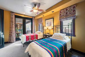 Bedroom featuring french doors, ceiling fan, and carpet flooring