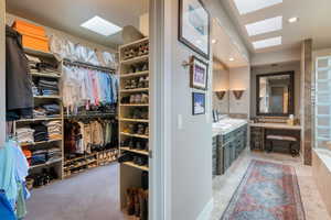 Spacious closet featuring a skylight