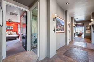 Corridor featuring baseboards and recessed lighting