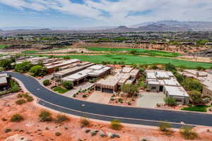 Aerial perspective of suburban area featuring mountains and a local golf course
