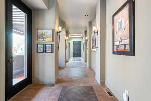 Corridor with tile patterned floors and baseboards