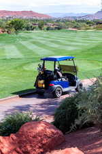 View of parking / parking lot featuring a mountain view and golf course view