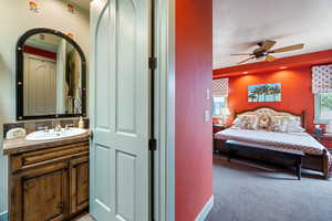 Bathroom featuring vanity and a ceiling fan