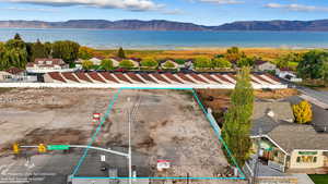 Aerial view of residential area with a water and mountain view and property parcel outlined