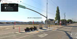 View of asphalt road with a residential view, curbs, traffic signs, and sidewalks
