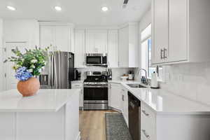 Kitchen featuring appliances with stainless steel finishes, recessed lighting, white cabinetry, and light wood finished floors
