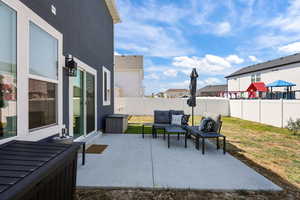 Fenced backyard with an outdoor living space, a patio area,