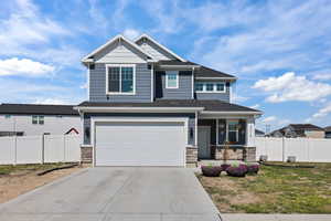 Craftsman-style home featuring covered porch, stone,  siding, large  driveway, Room for RV Parking  & Garage