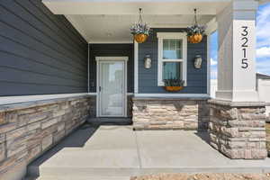 Covered Porch and lots of Stone..