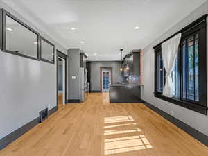 Reception with recessed lighting and crown molding