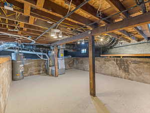 Unfinished basement with water heater and heating unit