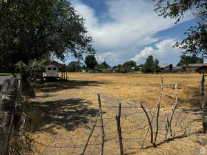 View of yard featuring a storage shed and a view of countryside