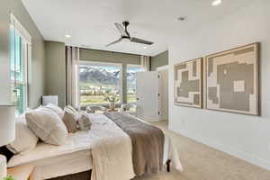 Bedroom with light colored carpet, recessed lighting, a mountain view, and a ceiling fan
