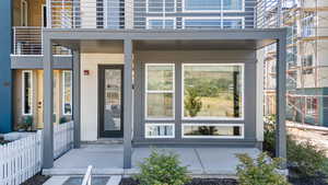 Doorway to property featuring stucco siding