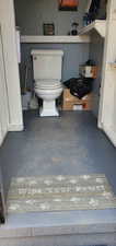 Bathroom with toilet and concrete floors
