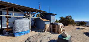 View of side of home featuring a storage unit