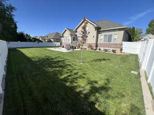 Fenced backyard featuring a patio area