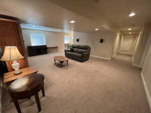 Large basement family room w/ kitchenette in the back ground