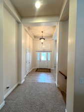 Doorway featuring carpet floors and tile patterned flooring